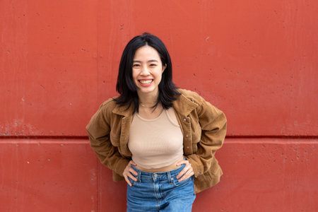 Portrait happy young asian woman smiling by wallの写真素材