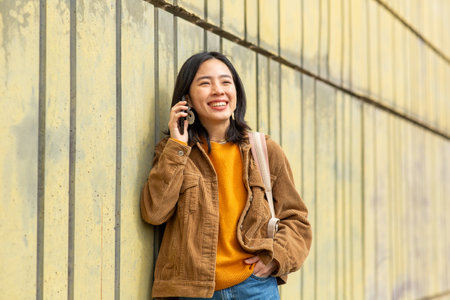 Portrait smiling young woman talking with cellphoneの写真素材