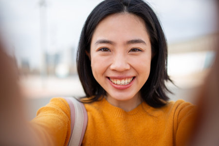 portrait happy young asian woman taking selfieの写真素材