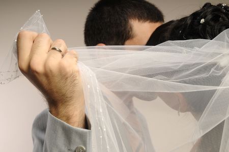 Wedding kiss between groom and brideの写真素材