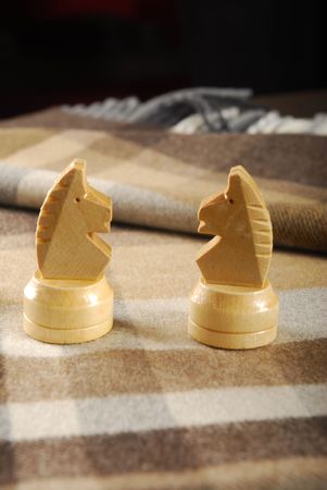two white chess knights on checked scarfの写真素材