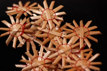 Straw ornaments on black backgroundの写真素材