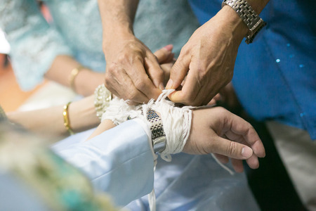 The bride and groom 's hands will be tied with thread from the older culture in Wedding ceremony north of Thailandの写真素材