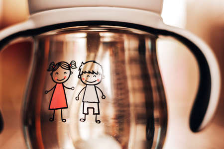 Baby boy and girl on the background of a water bottle.の写真素材