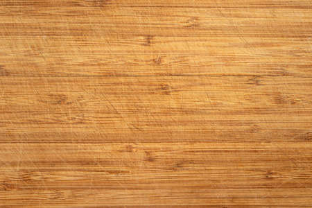Wooden cutting bottom with knife marks.