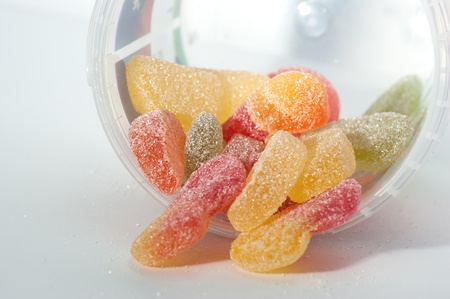 Colored gummy candies in the jar sprinkled with sugarの写真素材