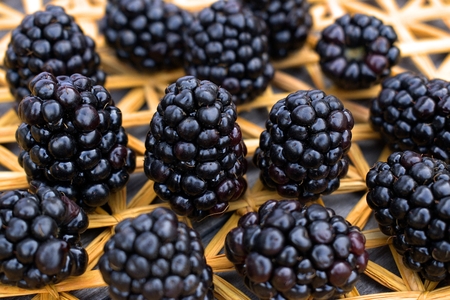 Fresh blackberries on a background of a straw mat.の写真素材