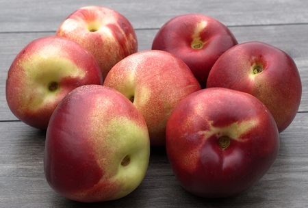Nectarines on wooden table.の写真素材