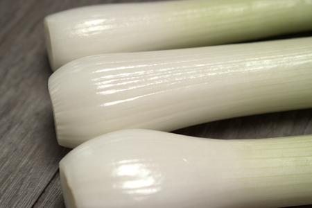 Young onions on wooden background.の写真素材