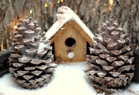 Close up of a cone and fence with light bulbs on snow background.の写真素材