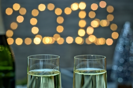 New year concept - champagne glasses on a blurry gold background new year.