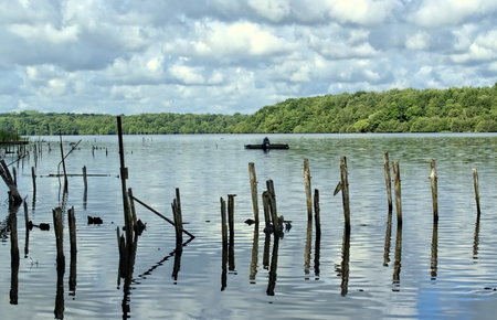 Nature, environment and landscape concept. A fisherman on a boat.の写真素材