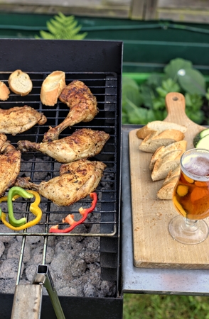 Tasty food, nutrition, culinary concept: grilled chicken thigh and vegetables on a barbeque.の写真素材