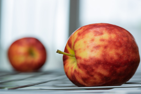 Ripe, colorful mottled apples on a bright background.の写真素材