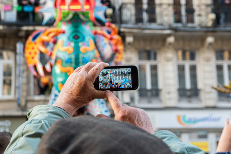 Lille, FRANCE-May 04,2019: Man who makes videos with a mobile phone