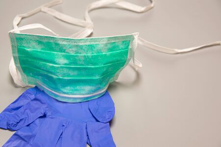 Health, safety and protective concept: Medical mask and gloves on gray background, protection...