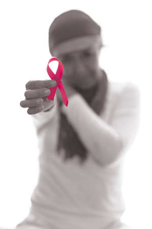 Hispanic lady dressed in white with a pink scarf on her head, thoughtful and happyの写真素材