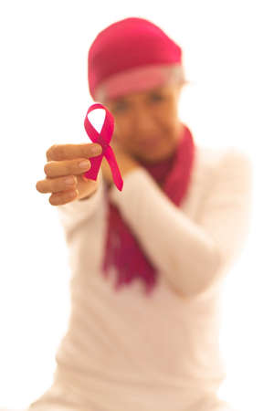 Hispanic lady dressed in white with a pink scarf on her head, thoughtful and happyの写真素材