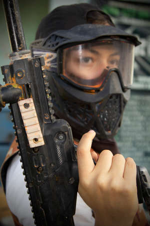 Gotcha players with protective mask, gun and wild attitude. Paint Bullet Playersの写真素材