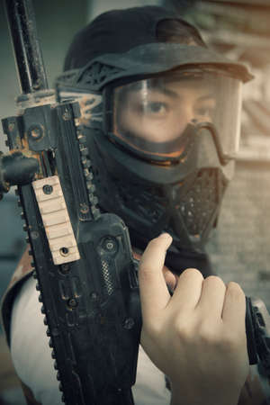 Gotcha players with protective mask, gun and wild attitude. Paint Bullet Playersの写真素材
