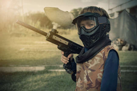 Gotcha players with protective mask, gun and wild attitude. Paint Bullet Playersの写真素材