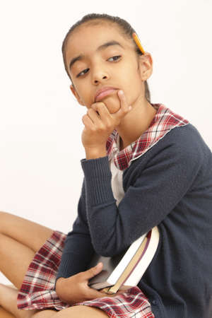 brunette latin student with school uniform in pose of analyzing