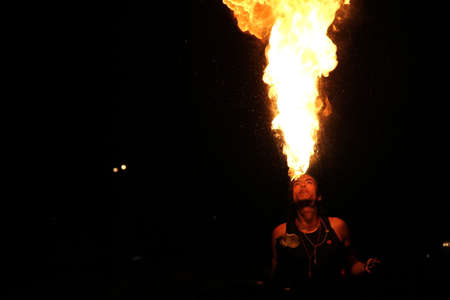 Young man makes a living as a fire eater on the streetのeditorial素材