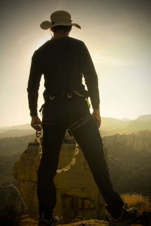 young man triumphing in the mountains. Conquering his fears. Confronting fearの写真素材