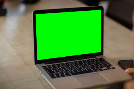 laptop with green screen in home work area. home office.の写真素材