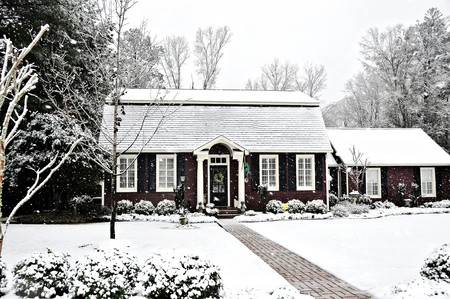 A salt box style home covered with fresh snow.の写真素材
