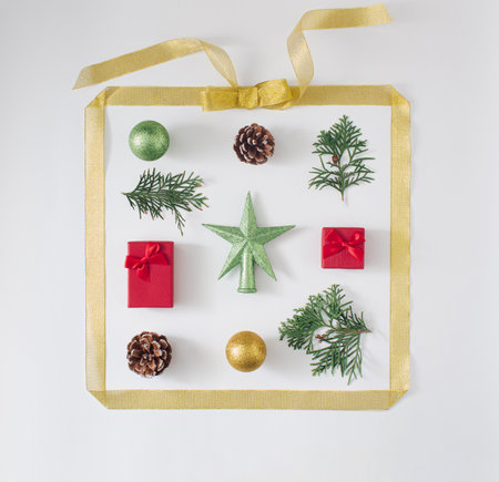 Christmas gold frame  with complementary green, red, brown colors of ornaments with nature elements. Flat lay design.の写真素材