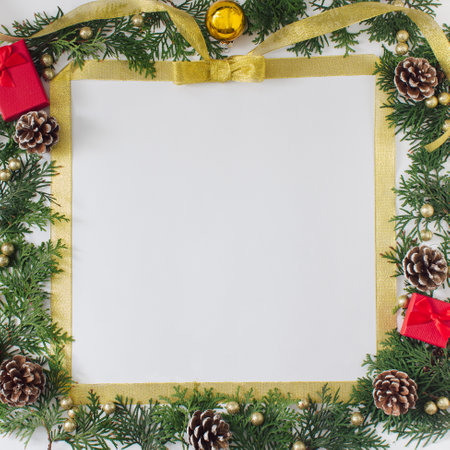 Christmas square frame  with complementary red, gold and brown color of ornaments  on nature elements. Flat lay design.の写真素材