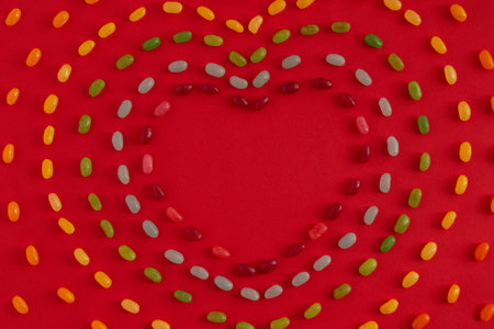 Valentines day heart shaped concept out of sweets on bright red background. Flat lay.の写真素材
