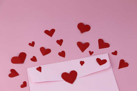 Cut the heart-shaped paper, put on a pink background. Valentine's Day Concepts