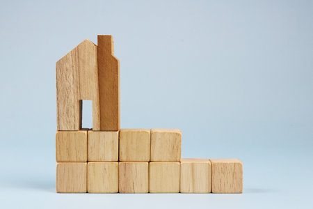 wooden building blocks on a white background. The concept of buying and selling real estateの写真素材