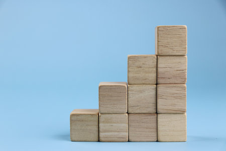 Wooden blocks on a blue background. Business and finance concept.