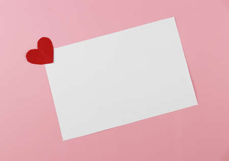 A blank white card for filling text and with handmade heart-shaped paper. Valentine's Day Concepts.の写真素材