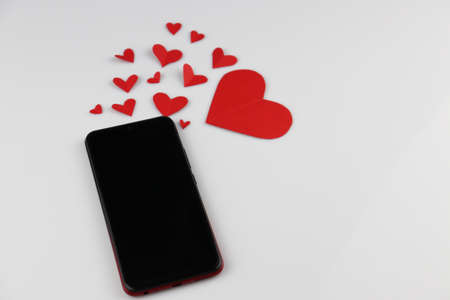 Mobile phone with red heart shape Valentine's Day Messaging Conceptsの写真素材