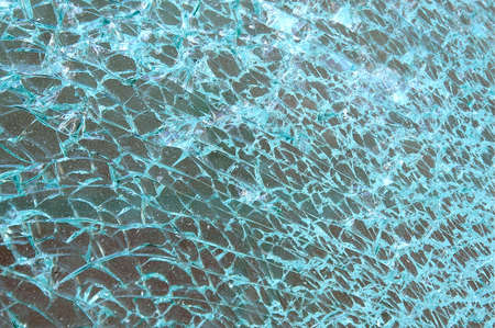 Broken and cracked dirty window glass into thousand of pieces