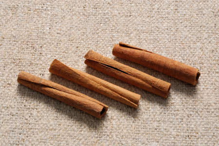 Cinnamon sticks on a linen fabric backgroud