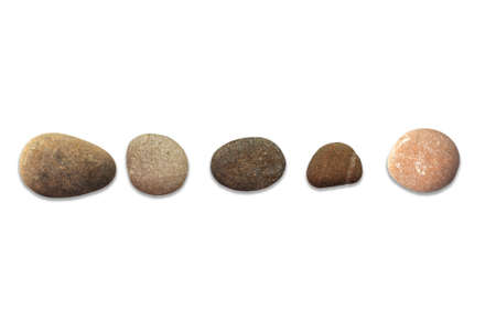 Various shapes and colors of river gravel on a white backgroundの写真素材