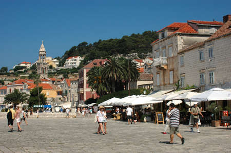 Hvar, Croatia - July 04, 2010:  Tourists enjoy a summer walk on the main Hvar square in Croatia, on...