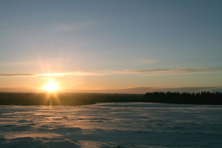 Las minits of sun. Big field coverd with snow. Cold weatherの写真素材
