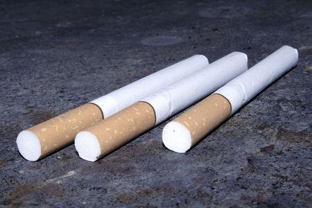Some cigarettes are on a dirty floor. Don`t smokeの写真素材