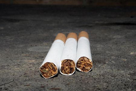 Some cigarettes are on a dirty floor. Don`t smokeの写真素材