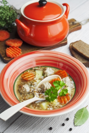 Meatball soup and buckwheat in a bowl on the tableの写真素材