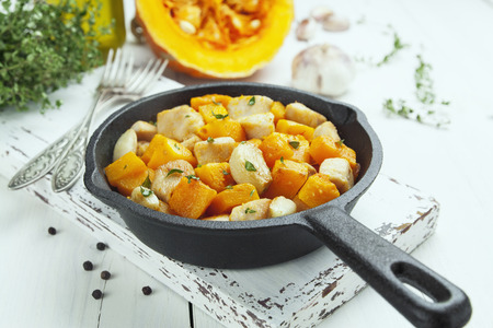 Pumpkin baked with chicken in the frying panの写真素材