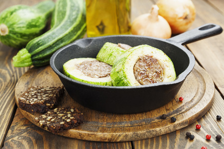Zucchini with meat in the frying pan on the tableの写真素材