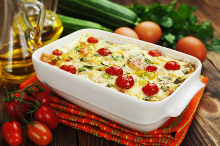 Baked zucchini with chicken, cherry tomatoes and herbs in a ceramic pot の写真素材