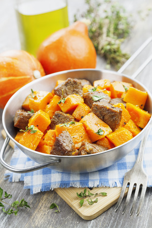 Pumpkin, baked with beef in the pot on the tableの写真素材